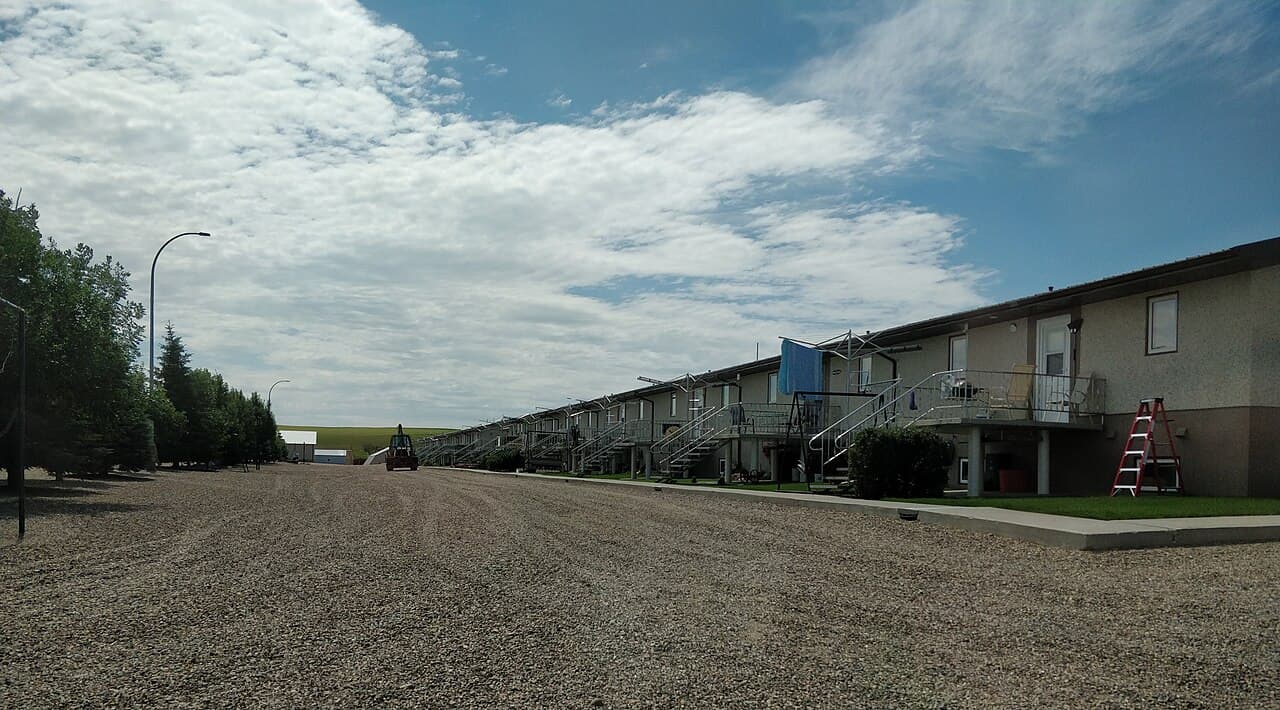 A Hutterite colony. Settlements split when membership exceeds about 150 — beyond that point, the community reports, social pressure alone cannot maintain norms.
