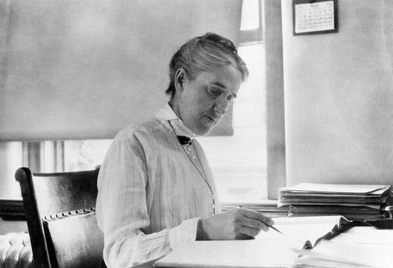 Henrietta Swan Leavitt at her desk at the Harvard College Observatory. The hand magnifier and glass plates were the standard equipment of the 'computers'.