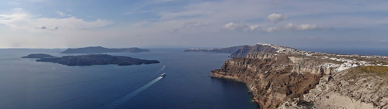 The Santorini caldera. The cliffs are the inner walls of the collapse that the 1600 BCE eruption produced; the modern islands of Thira, Therasia, Aspronisi, Palea Kameni, and Nea Kameni are its surviving fragments.